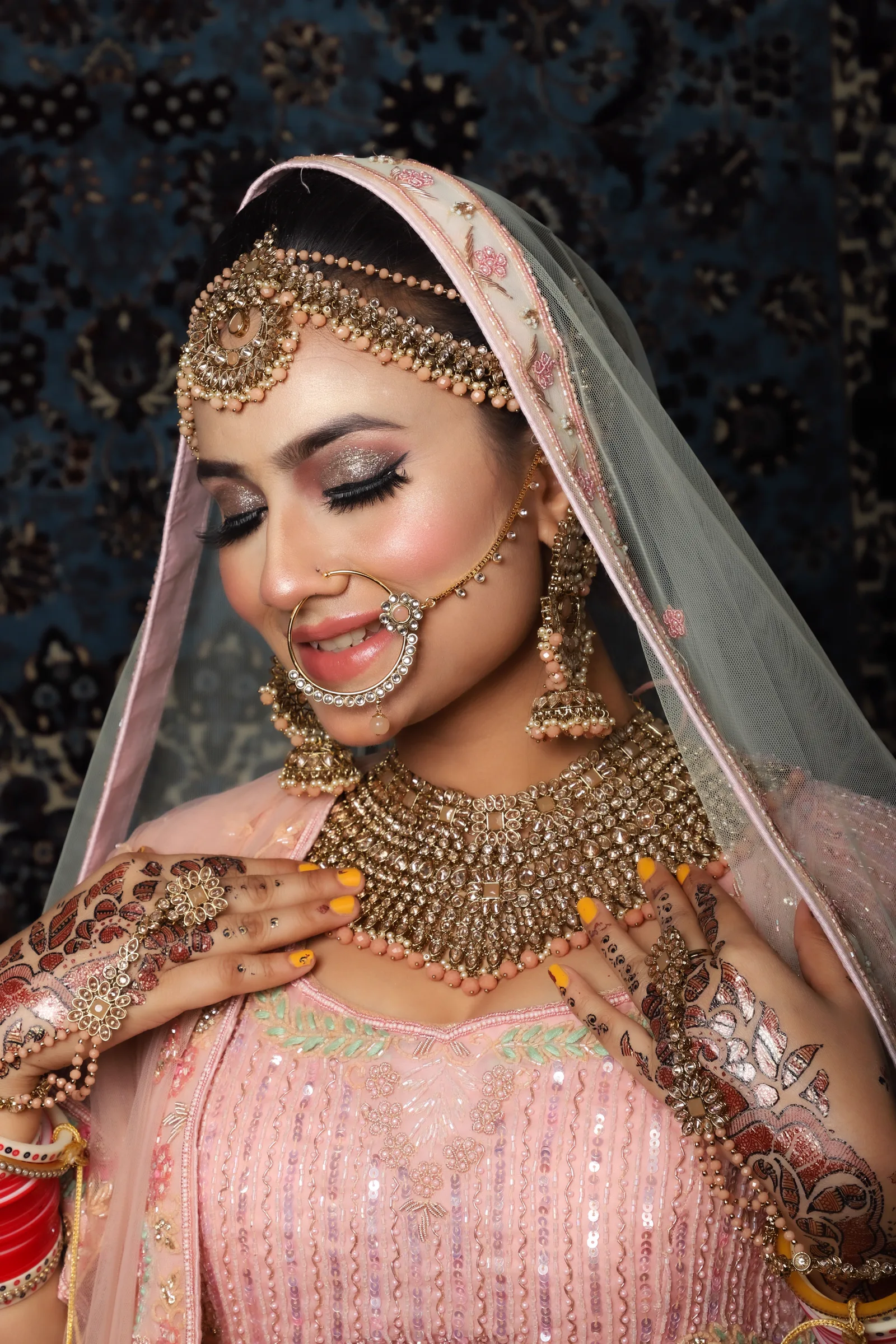 Mehndi — Glow-first makeup that photographs beautifully beside intricate mehndi detail.